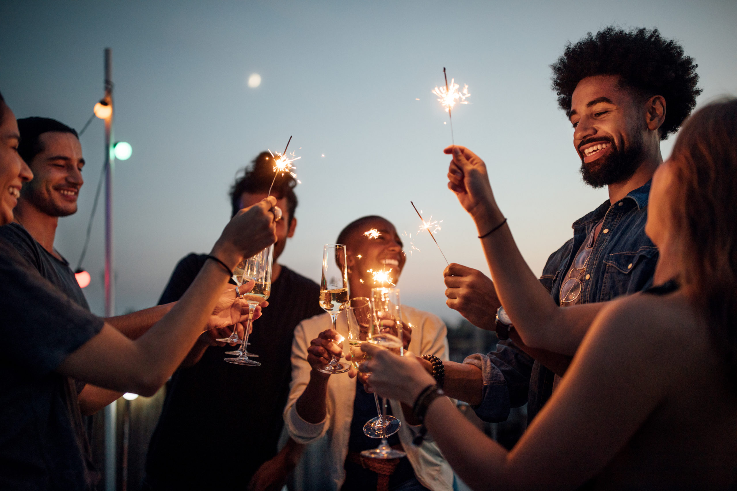 Friends celebrating at party on rooftop