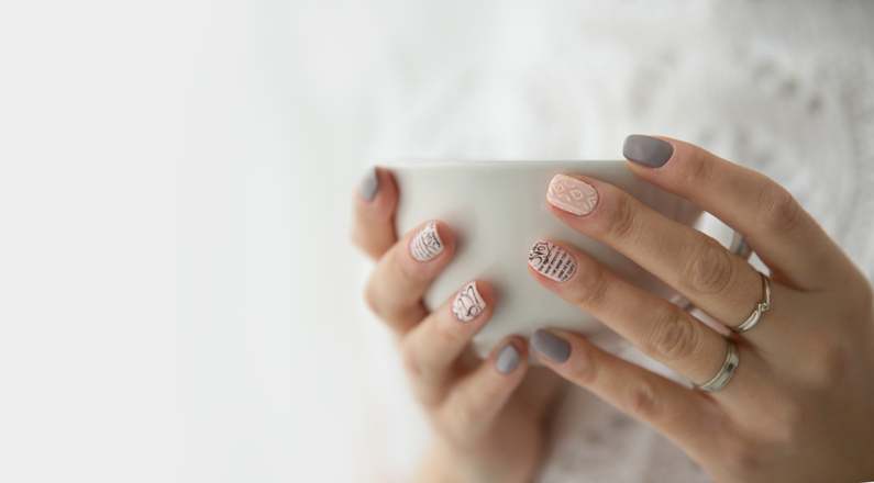 beautiful woman's hands holding a white cup
